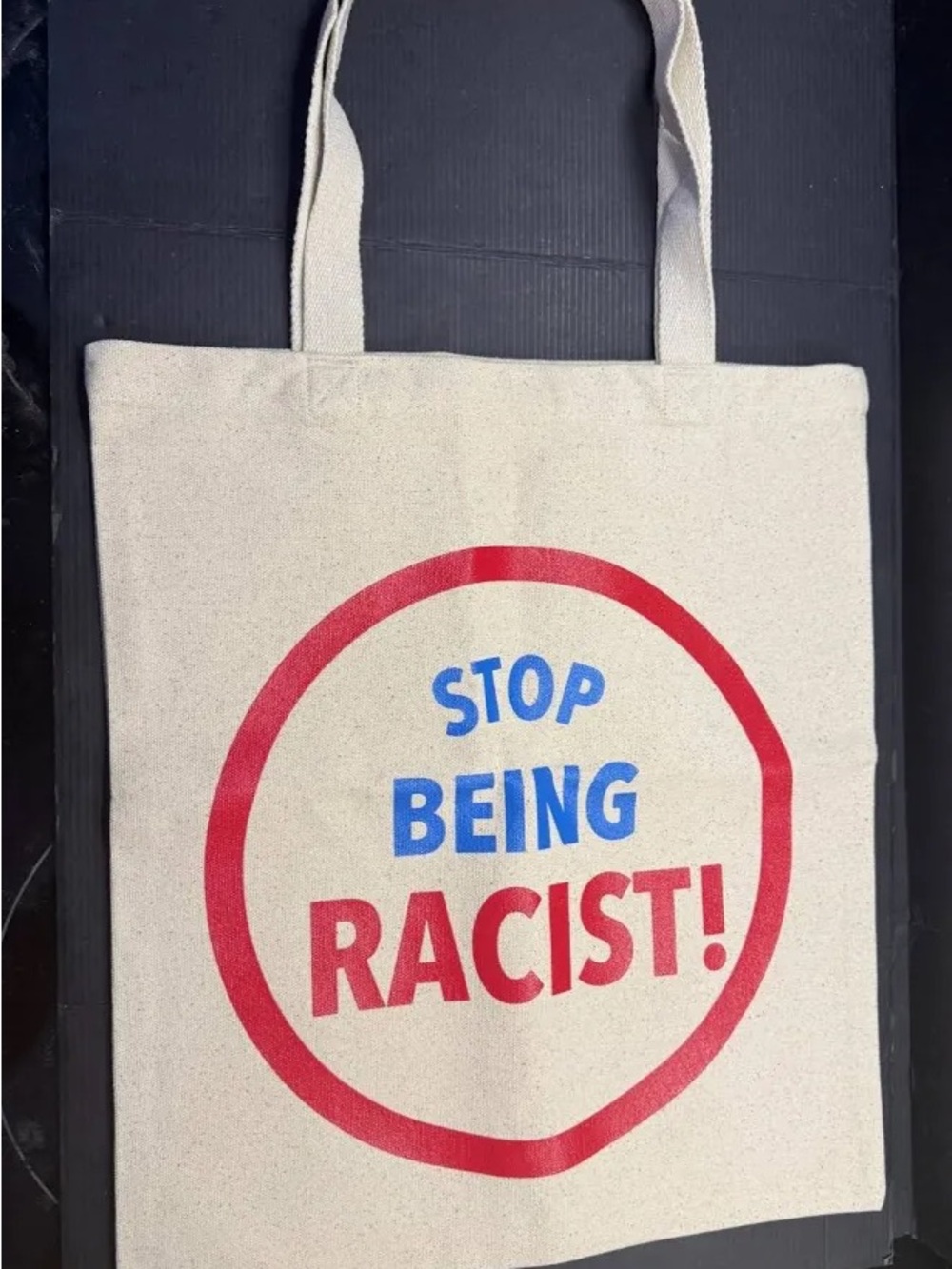 Gallery Dept “Sop being racist!”Cream Canvas Tote with Yellow Logo and red/blue